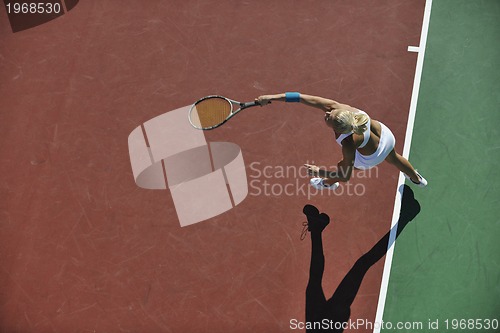 Image of young woman play tennis outdoor