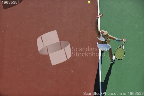 Image of young woman play tennis outdoor
