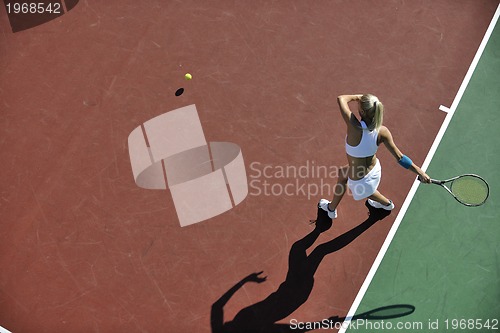 Image of young woman play tennis outdoor