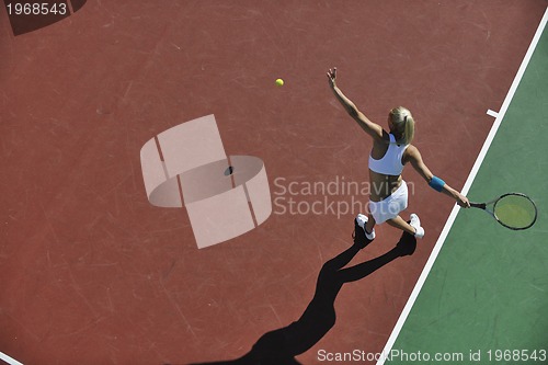 Image of young woman play tennis outdoor