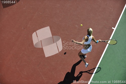 Image of young woman play tennis outdoor