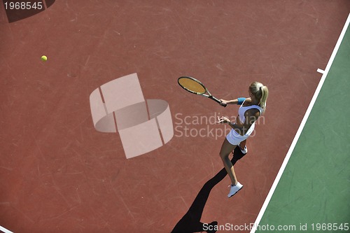 Image of young woman play tennis outdoor
