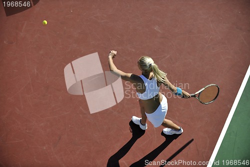 Image of young woman play tennis outdoor