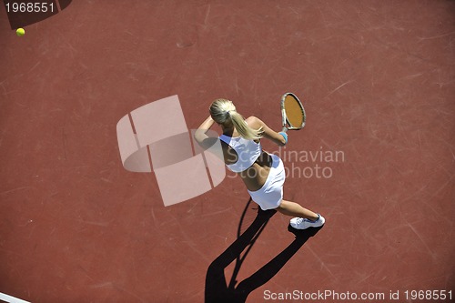 Image of young woman play tennis outdoor