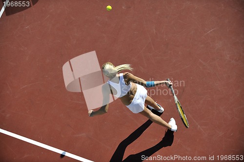 Image of young woman play tennis outdoor
