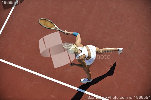 Image of young woman play tennis outdoor