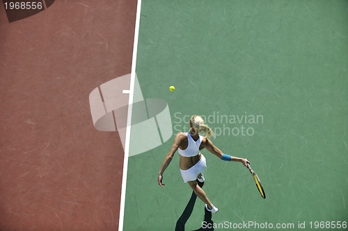 Image of young woman play tennis outdoor