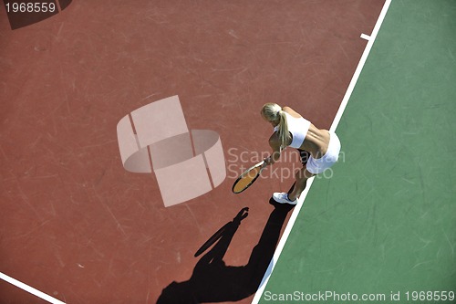 Image of young woman play tennis outdoor