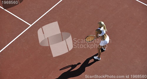 Image of young woman play tennis outdoor