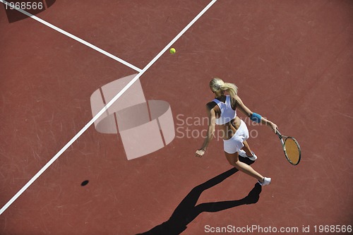 Image of young woman play tennis outdoor