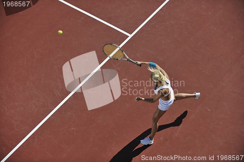 Image of young woman play tennis outdoor