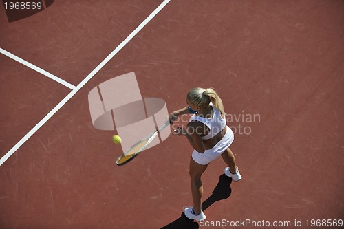 Image of young woman play tennis outdoor