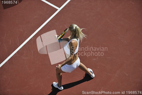 Image of young woman play tennis outdoor
