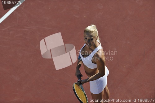 Image of young woman play tennis outdoor