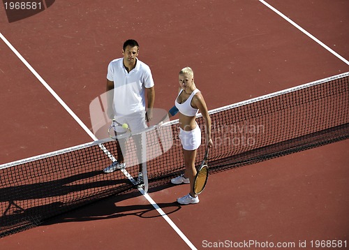 Image of happy young couple play tennis game outdoor