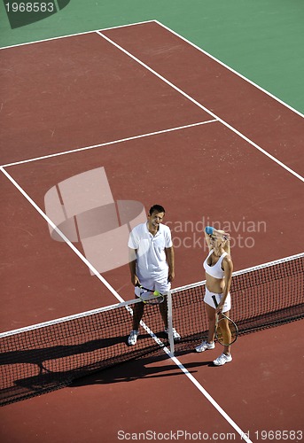 Image of happy young couple play tennis game outdoor