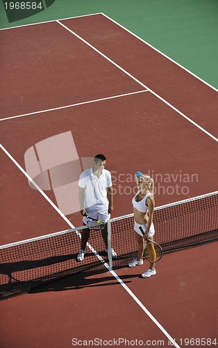 Image of happy young couple play tennis game outdoor