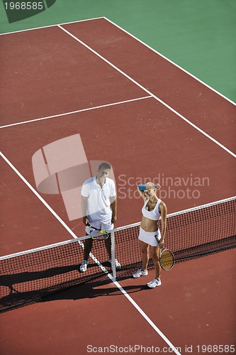 Image of happy young couple play tennis game outdoor