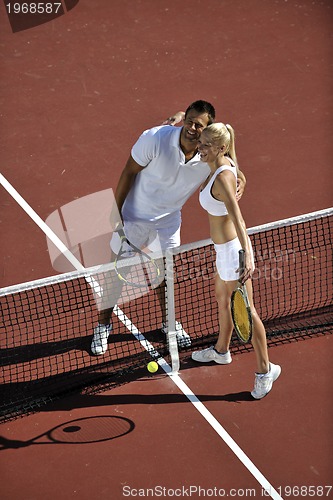 Image of happy young couple play tennis game outdoor