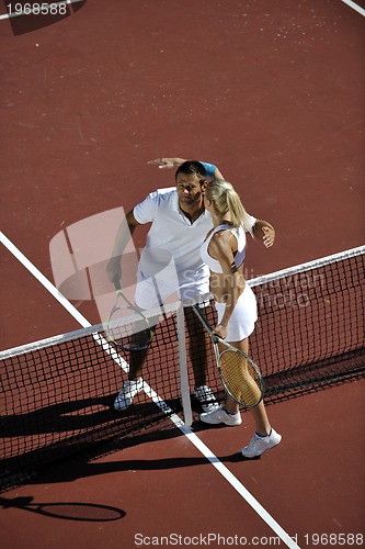 Image of happy young couple play tennis game outdoor