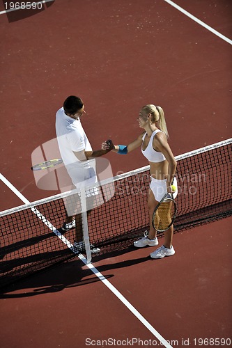 Image of happy young couple play tennis game outdoor