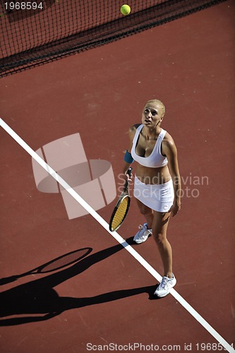 Image of young woman play tennis outdoor
