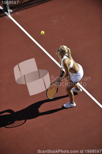 Image of young woman play tennis outdoor