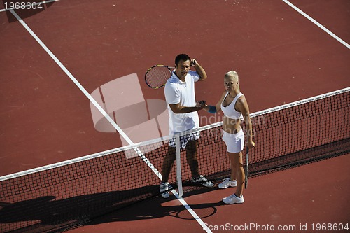 Image of happy young couple play tennis game outdoor