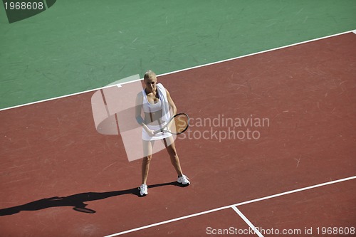 Image of young woman play tennis outdoor