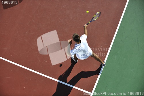 Image of young man play tennis outdoor