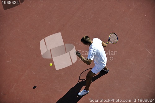 Image of young man play tennis