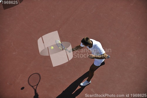 Image of young man play tennis outdoor