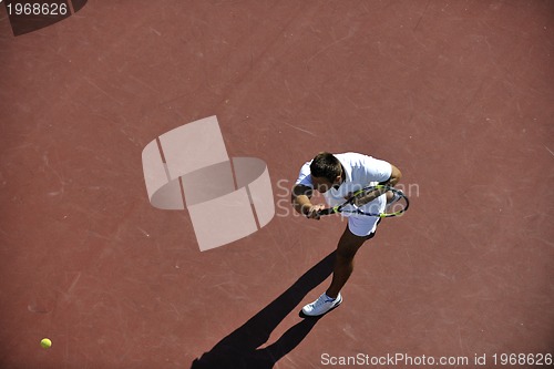 Image of young man play tennis