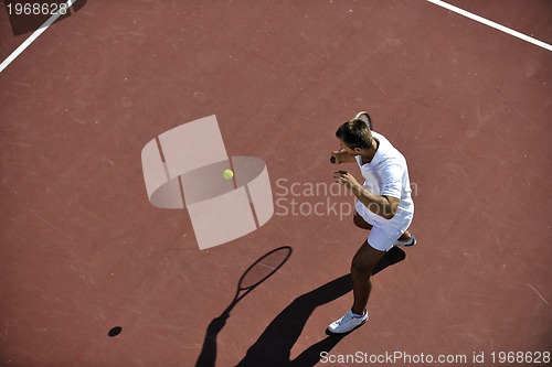 Image of young man play tennis