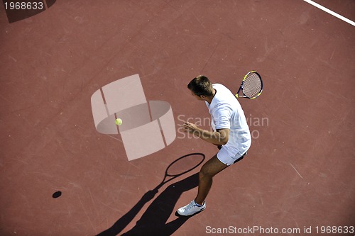 Image of young man play tennis