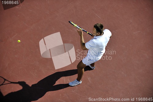 Image of young man play tennis