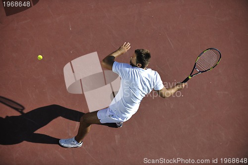 Image of young man play tennis