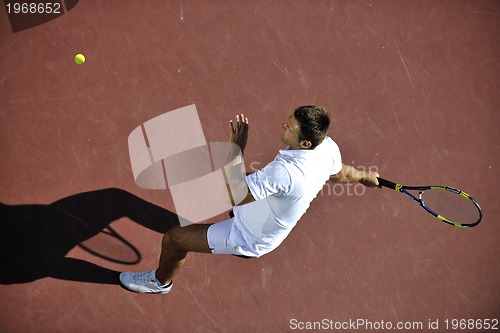 Image of young man play tennis