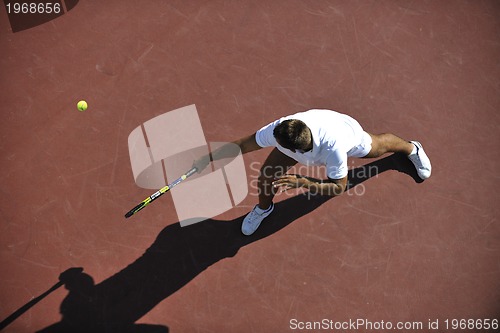 Image of young man play tennis outdoor