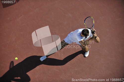 Image of young man play tennis outdoor