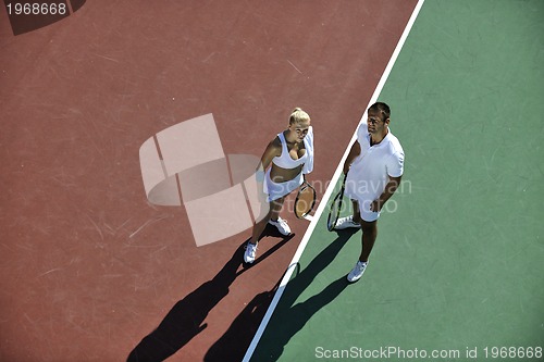 Image of happy young couple play tennis game outdoor