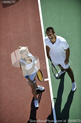 Image of happy young couple play tennis game outdoor