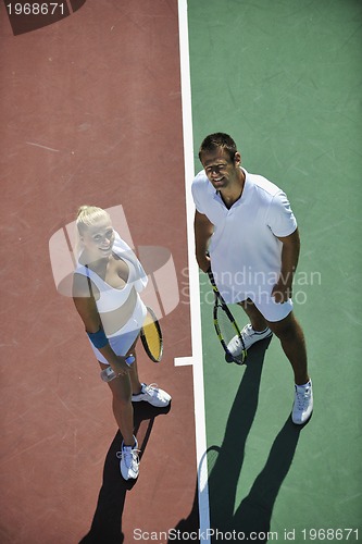Image of happy young couple play tennis game outdoor