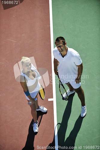 Image of happy young couple play tennis game outdoor