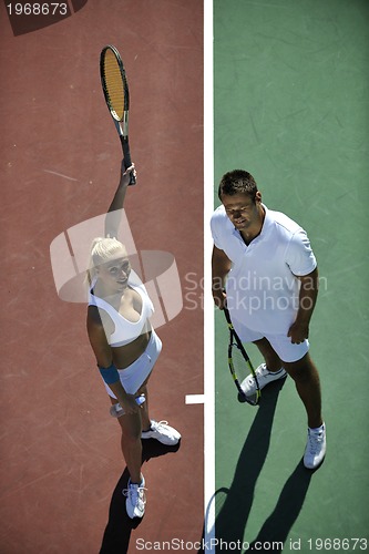 Image of happy young couple play tennis game outdoor