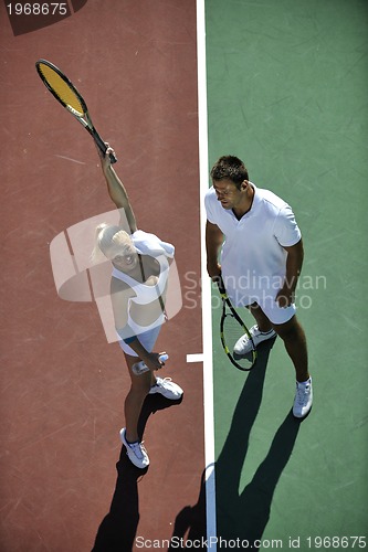 Image of happy young couple play tennis game outdoor