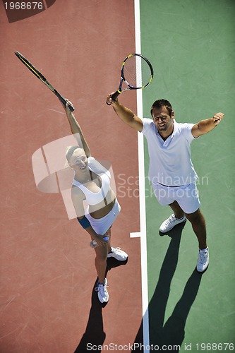 Image of happy young couple play tennis game outdoor