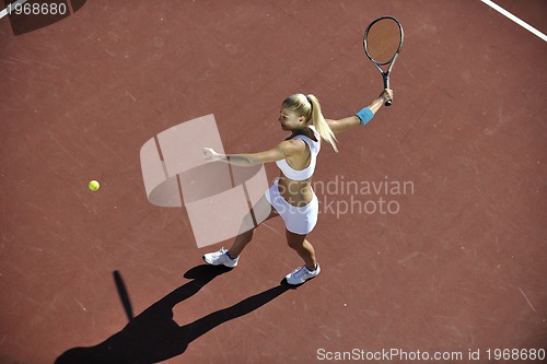 Image of young woman play tennis outdoor