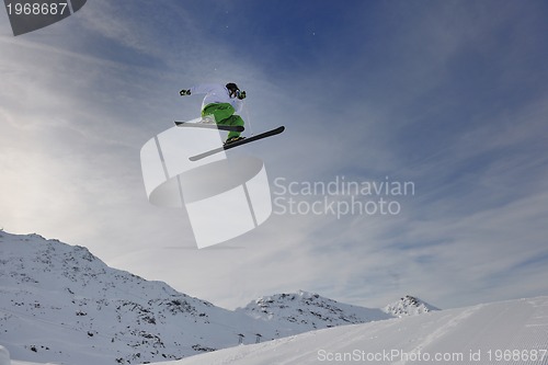 Image of happy young man have fun at winter on mountain peak