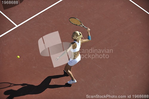 Image of young woman play tennis outdoor